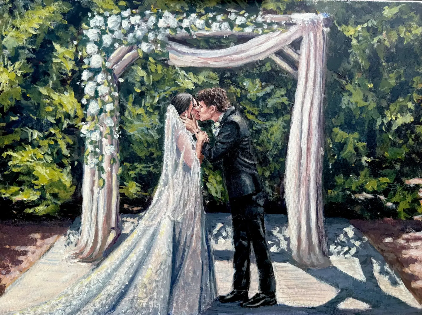 Live wedding painting of a bride and groom kissing beneath a floral pergola
