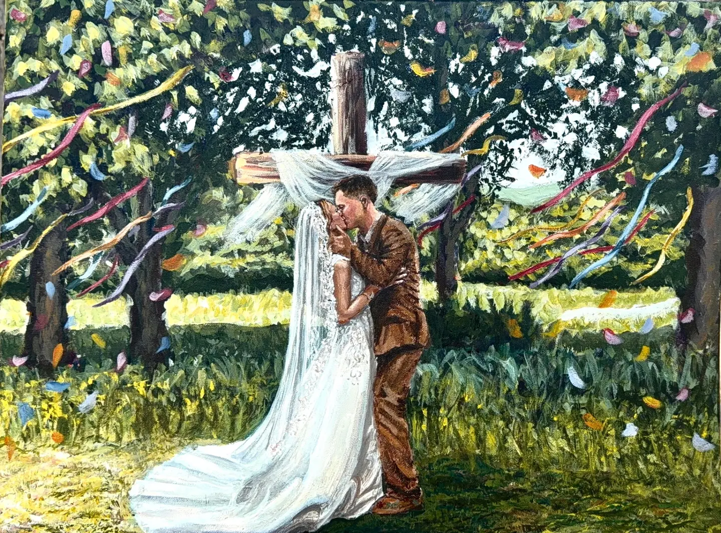 Live wedding painting of bride and groom kissing beneath a draped wooden cross with confetti and ribbons — Oklahoma wedding artist